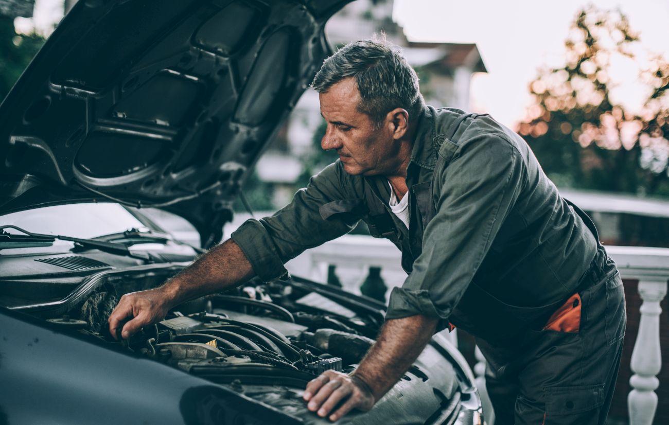 Man Working on His Own Car Engine Man Working on His Own Car Engine