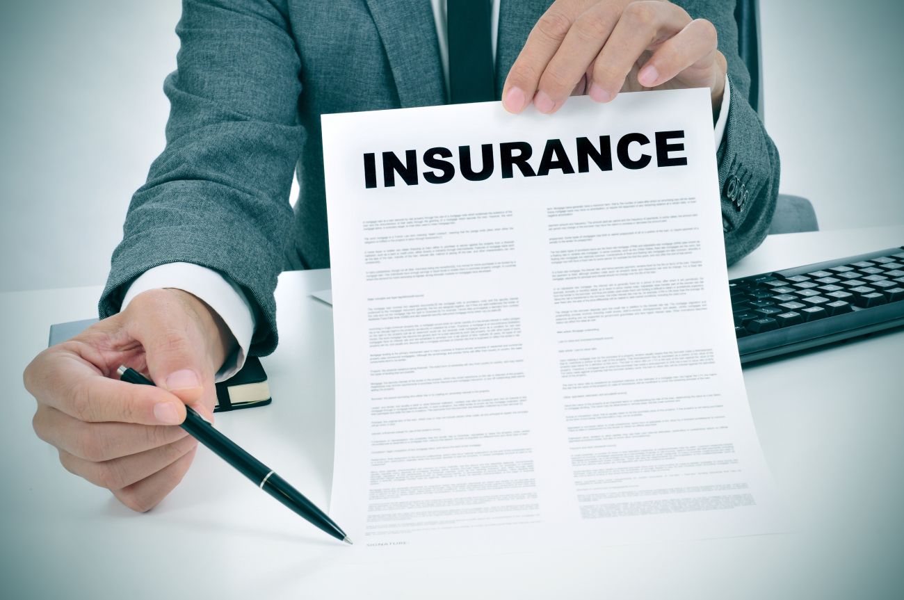 Insurance Agent Pointing to Insurance Application Insurance Agent Pointing to Insurance Application