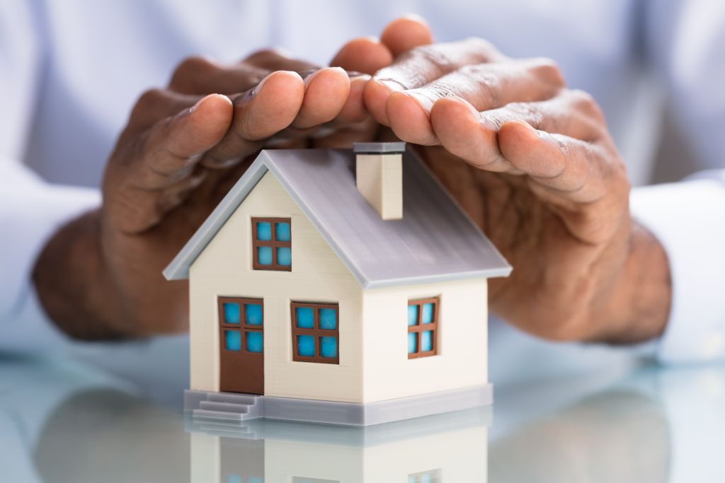 Hands Covering Mini House Hands Covering Mini House