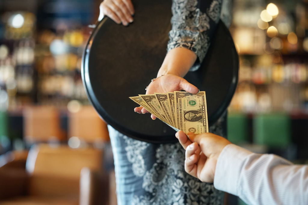 Customer Tipping Waiter in Restaurant Customer Tipping Waiter in Restaurant