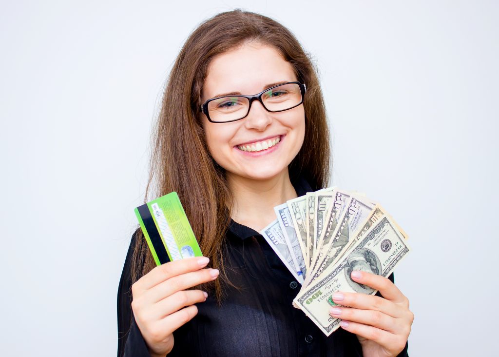 Credit Card and Cash in Hand Credit Card and Cash in Hand