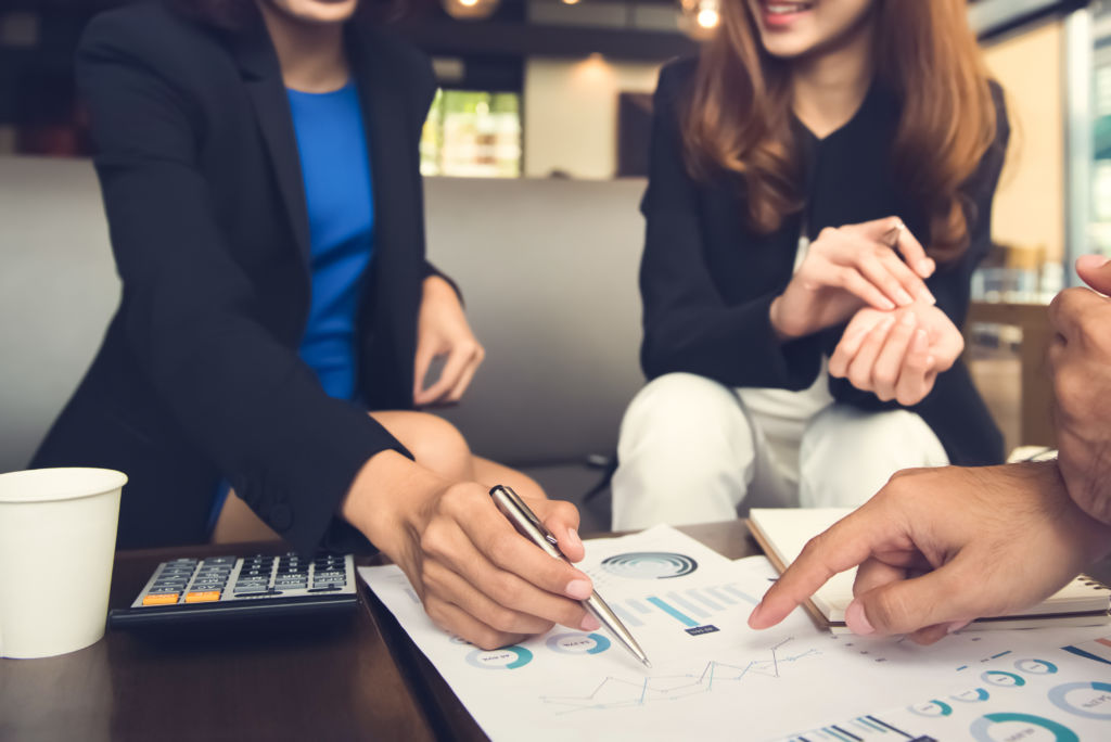 Couple Discussing Chart with Financial Advisor Couple Discussing Chart with Financial Advisor