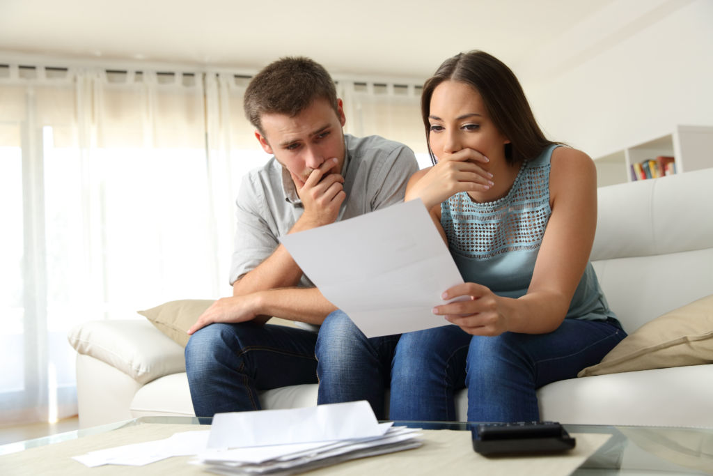 Couple Studying Bankruptcy Documents Couple Studying Bankruptcy Documents