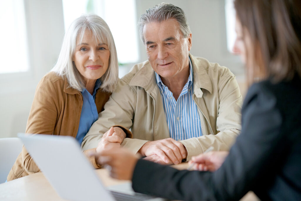 Retiring Couple Discussing Finances with Professional Retiring Couple Discussing Finances with Professional