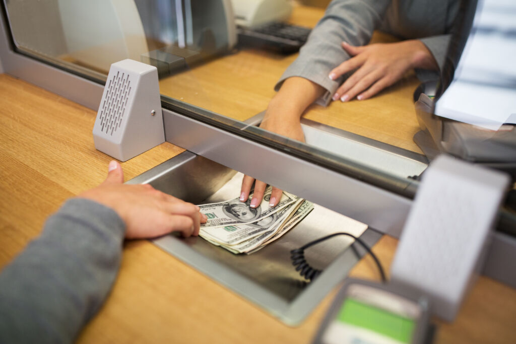 Woman Borrowing Money From Bank Teller Woman Borrowing Money From Bank Teller