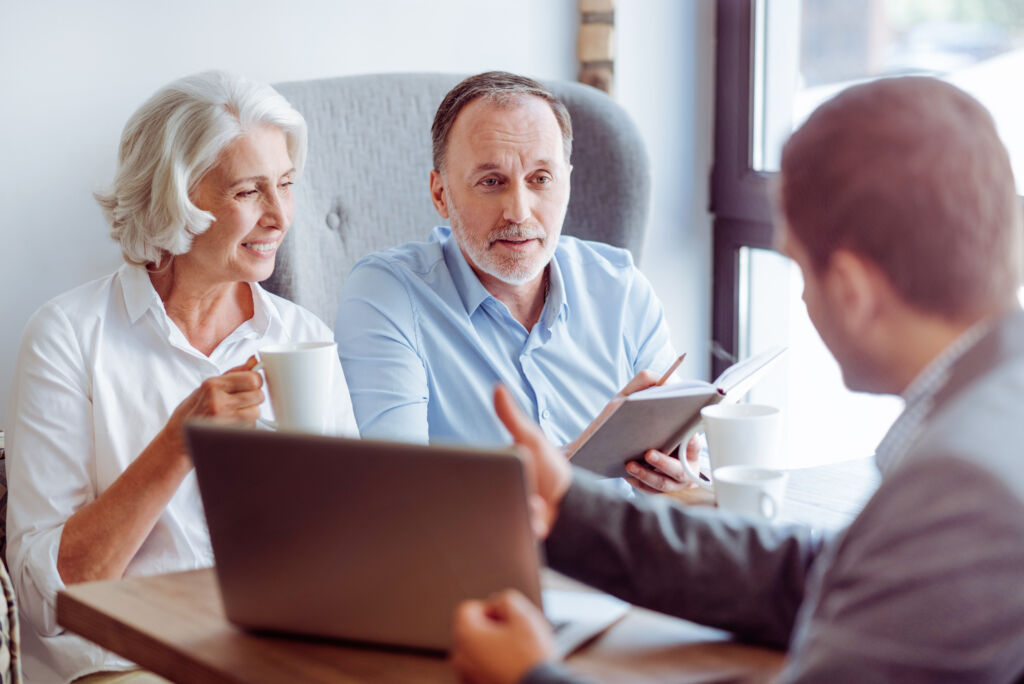 Older Couple Discussing Finances with Advisor Older Couple Discussing Finances with Advisor