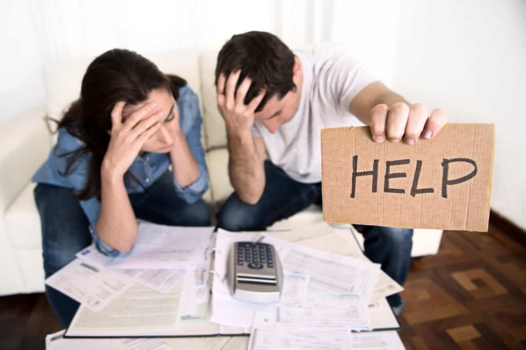 Couple Stressed About Finances Holding Help Sign Couple Stressed About Finances Holding Help Sign