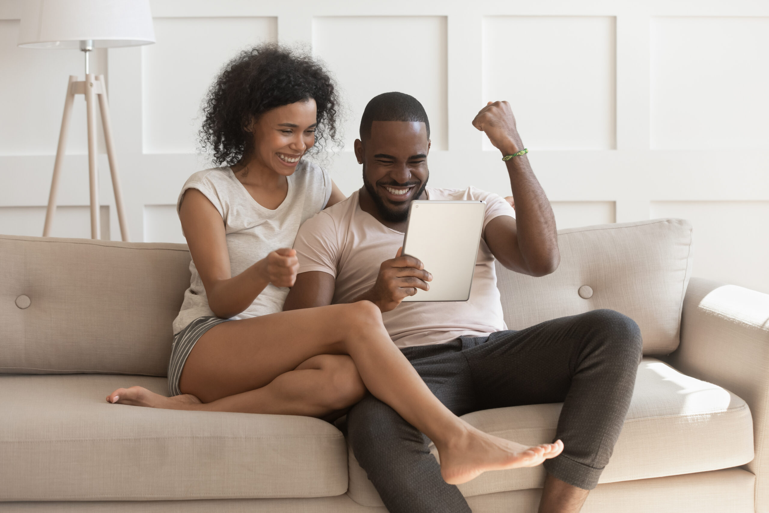 Happy couple winning a house bidding war