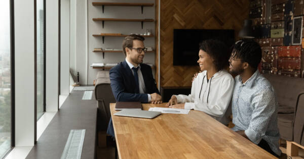 Young couple talking to insurance agent