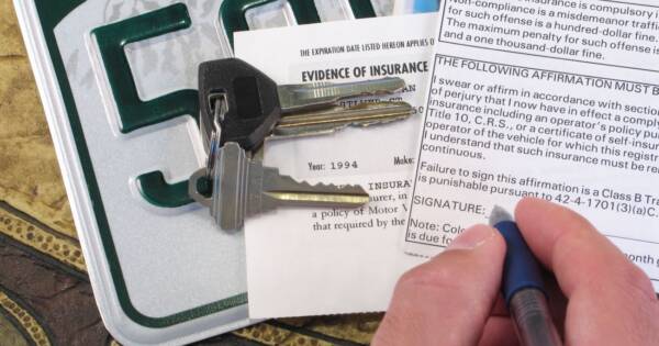 Signing Car Insurance Application with Keys and License