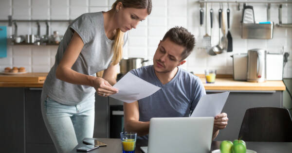 Roommates Discussing Rent in Kitchen