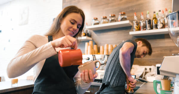 Woman Working as a Barista Pouring Coffee