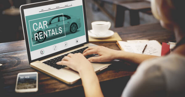 Woman Looking at Car Rental Website
