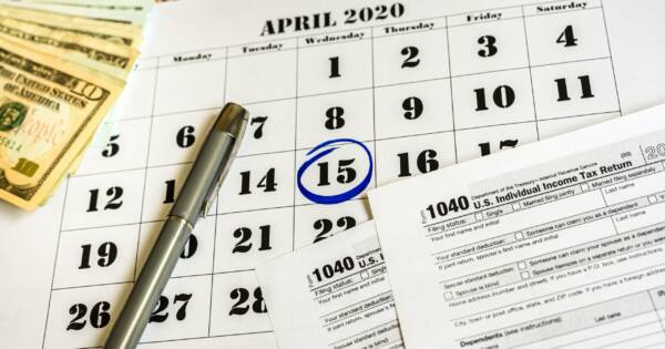 April 15th Circled on Calendar with Tax Forms