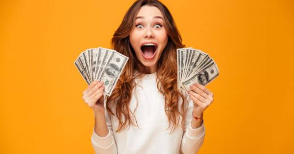 Woman Excited with Hands Full of Cash