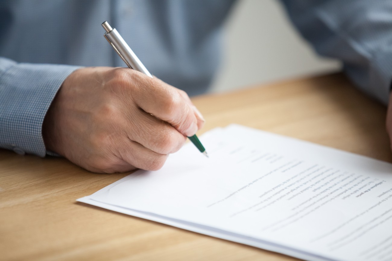 Elderly Hand Signing Documents Elderly Hand Signing Documents