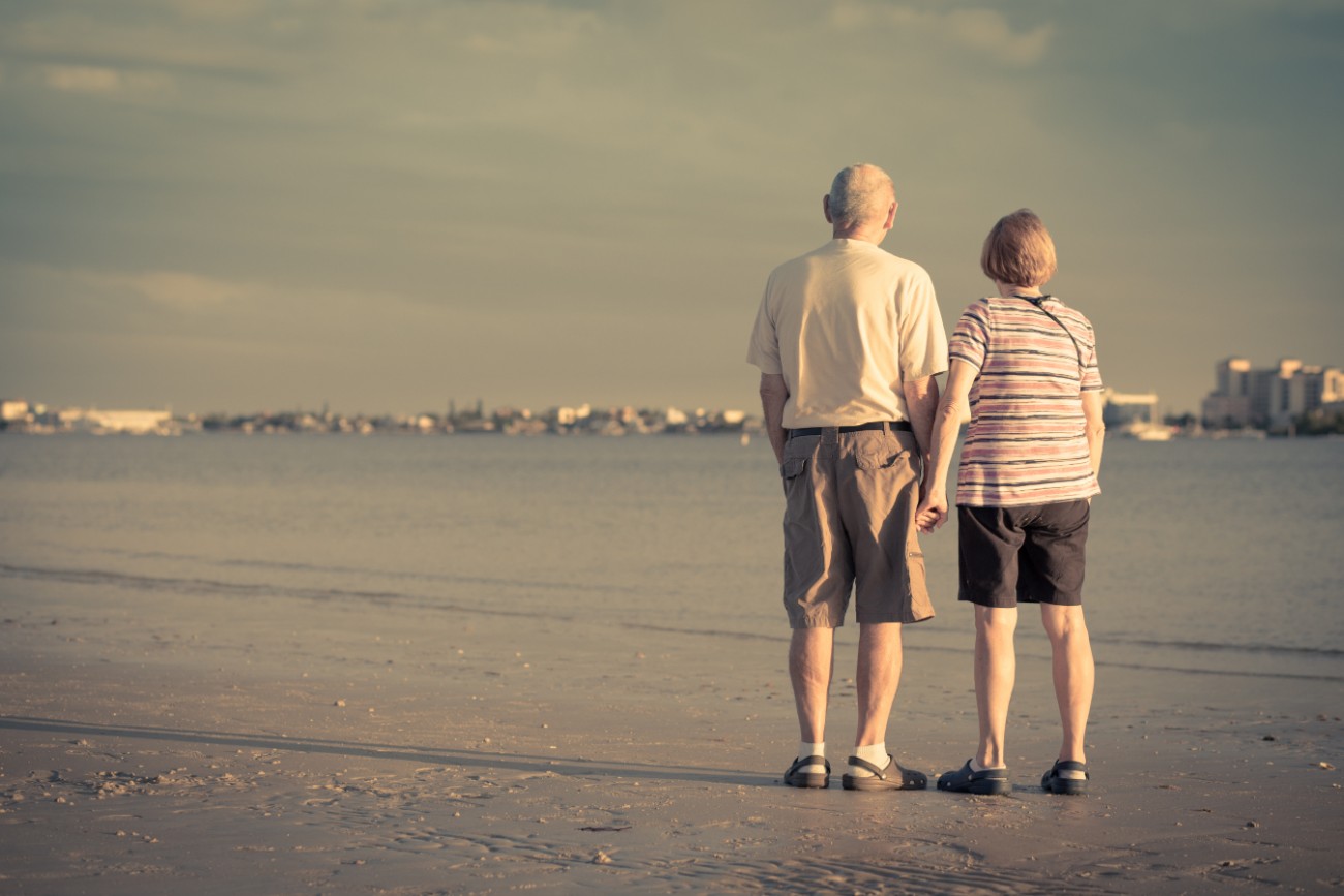 Retired Senior Couple Holding Hands at the Beach Retired Senior Couple Holding Hands at the Beach