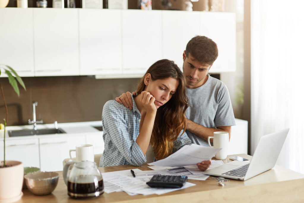 Couple Considering Debt in Kitchen Couple Considering Debt in Kitchen