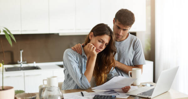 Couple Considering Debt in Kitchen