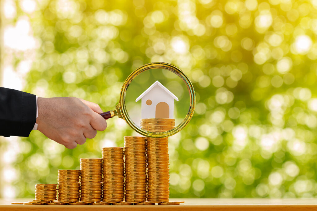 Gold Stack of Coins with Mini House on Top Gold Stack of Coins with Mini House on Top