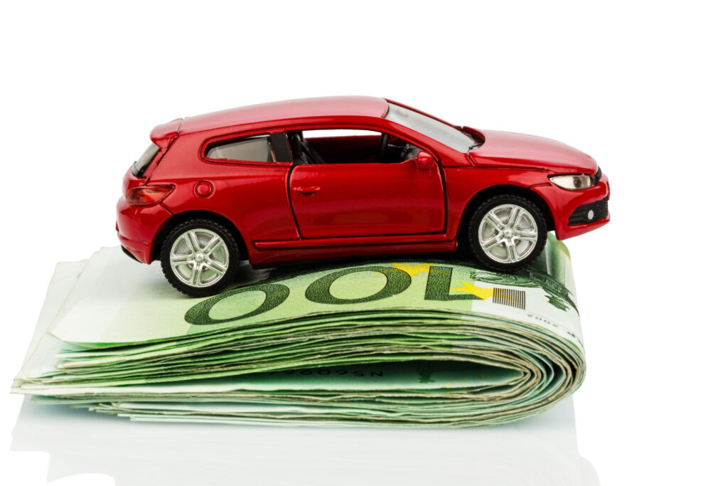 Red Toy Car on Folded Cash Red Toy Car on Folded Cash