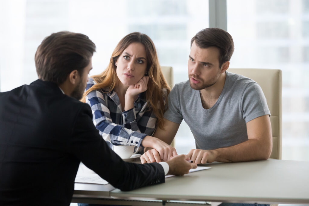 Couple Discussing Rental Scam with Business Professional Couple Discussing Rental Scam with Business Professional