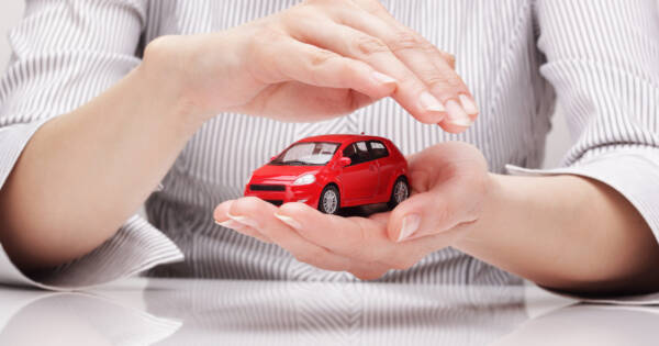 Woman Holding Mini Red Car
