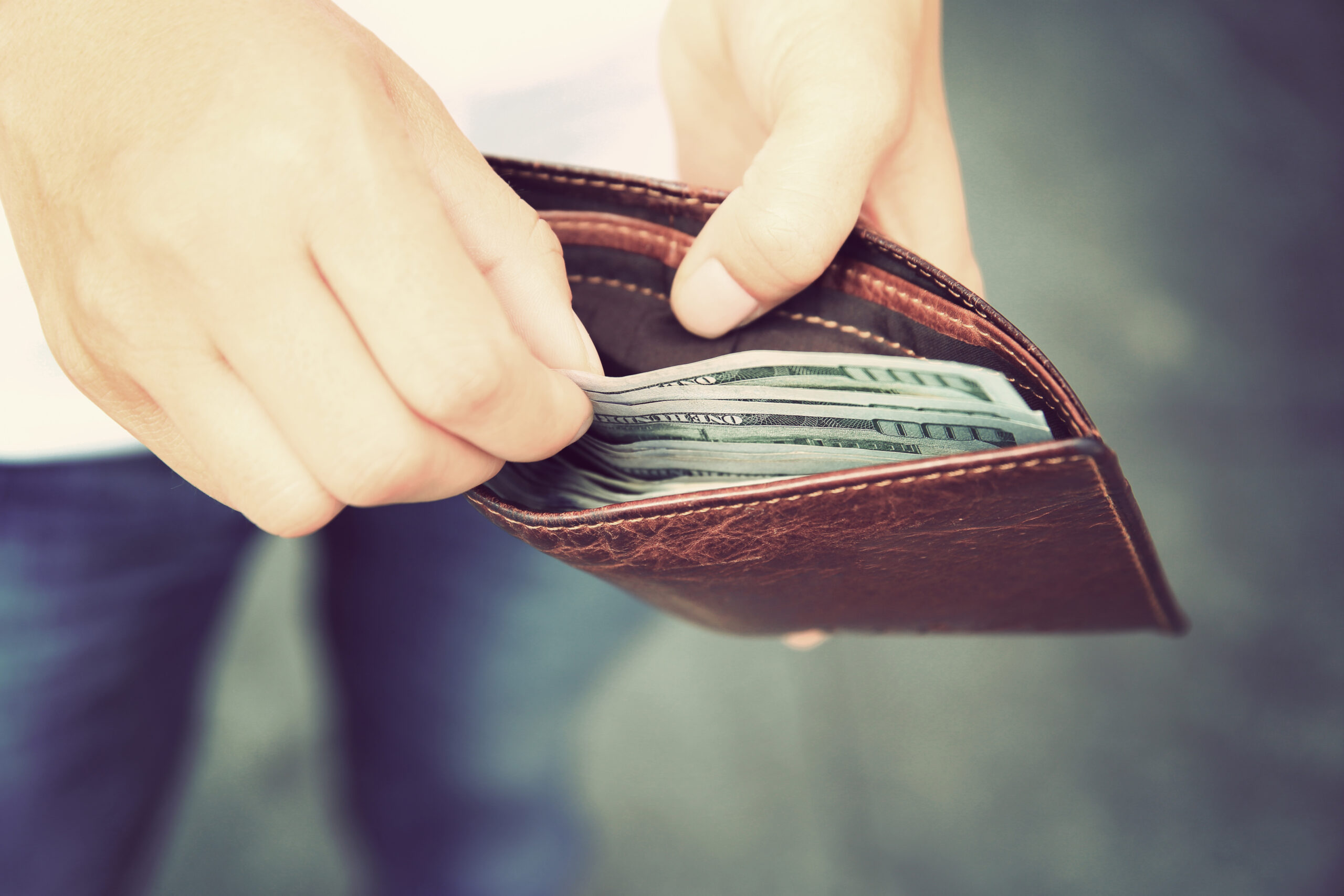 Man Pulling Money Out of Wallet Man Pulling Money Out of Wallet
