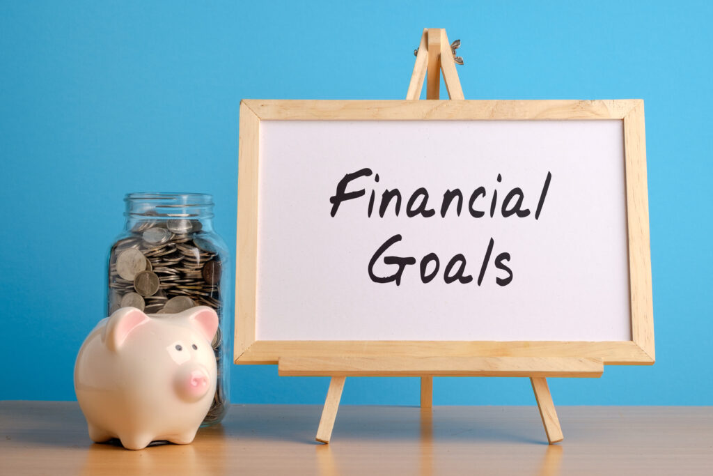 Financial Goals Whiteboard with Coin Jar and Piggy Bank Financial Goals Whiteboard with Coin Jar and Piggy Bank