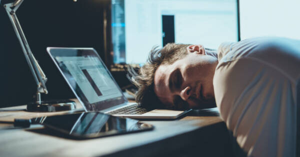 Man Sleeping on Laptop at Work