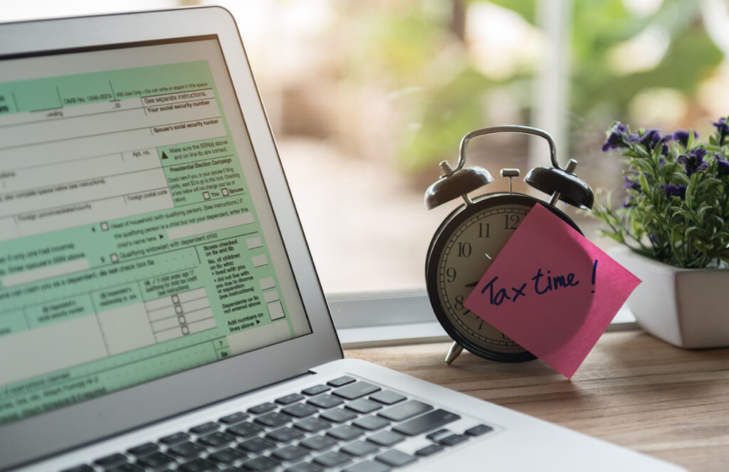 Desktop with Computer and Tax Time Note Desktop with Computer and Tax Time Note