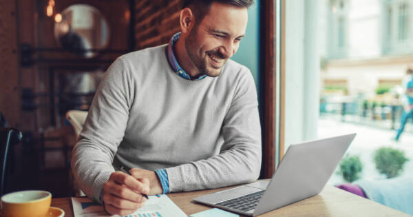 Man Working on Laptop at Coffee Shop