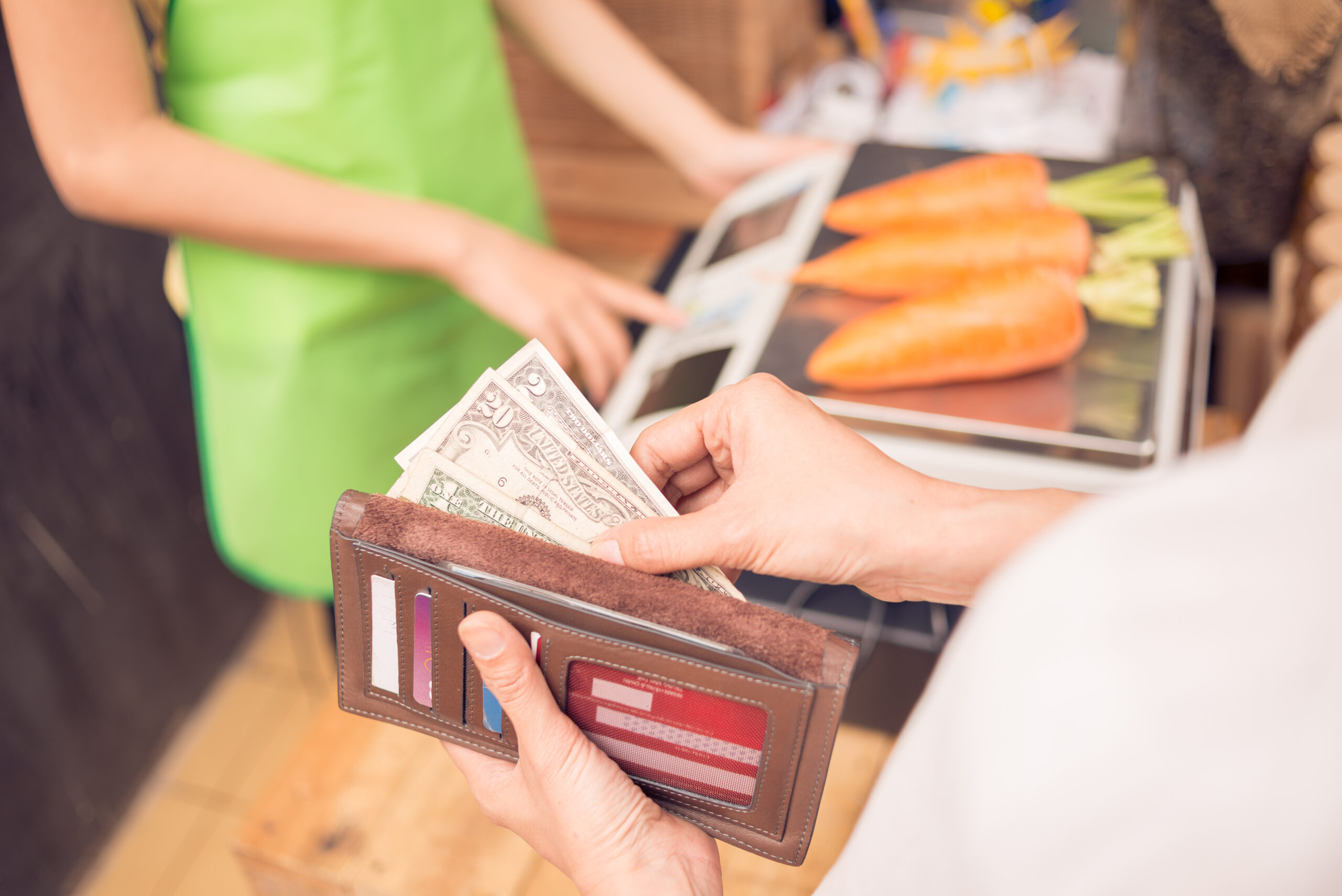 Woman Paying for Groceries at Checkout Woman Paying for Groceries at Checkout