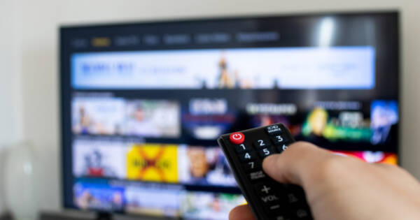 Person Browsing TV App with Remote