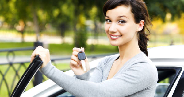 Young woman with a new car