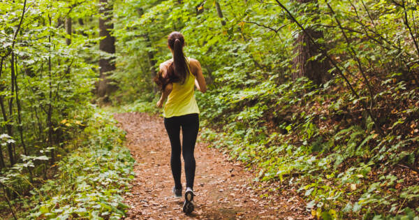 young woman running on a trail