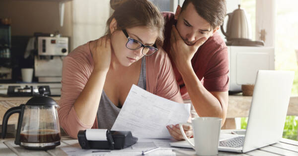 Young couple worrying about bills and budgeting